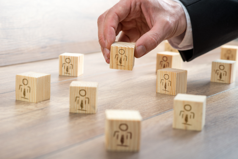 Blocks for Customer-Managed Relationship Concept Customer-Managed Relationship Concept - Businessman Arranging Small Wooden Blocks with Symbols on the Table.